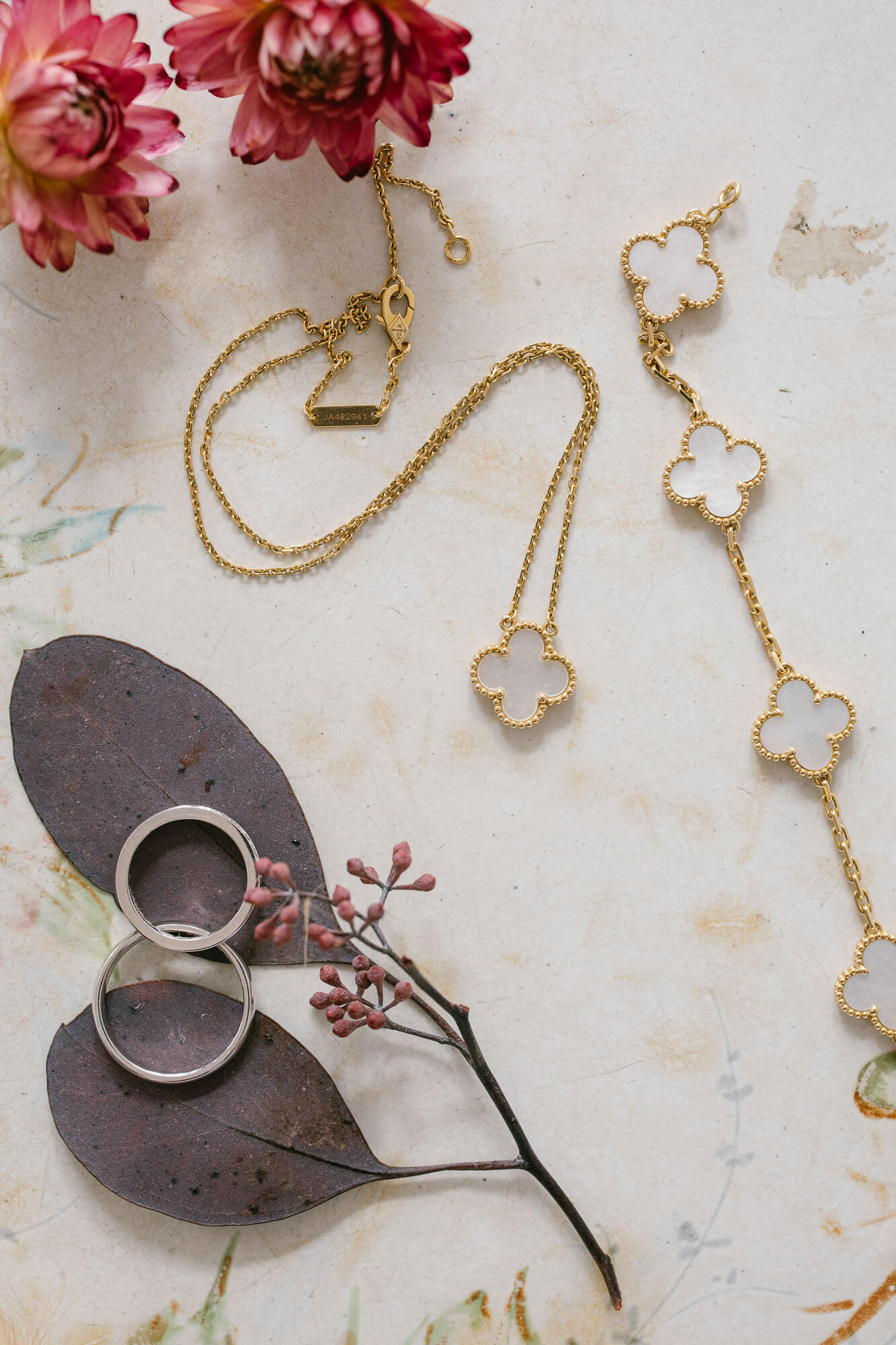 Bridal jewellery and wedding rings among dried flowers
