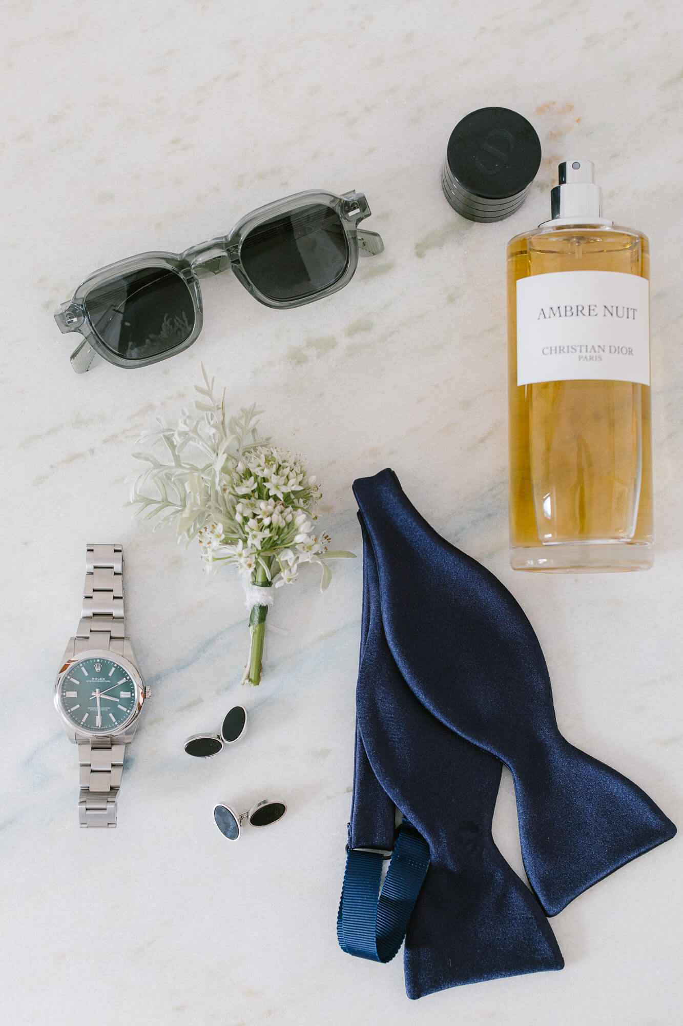 Groom's details: bow tie, watch, sunglasses and buttonhole
