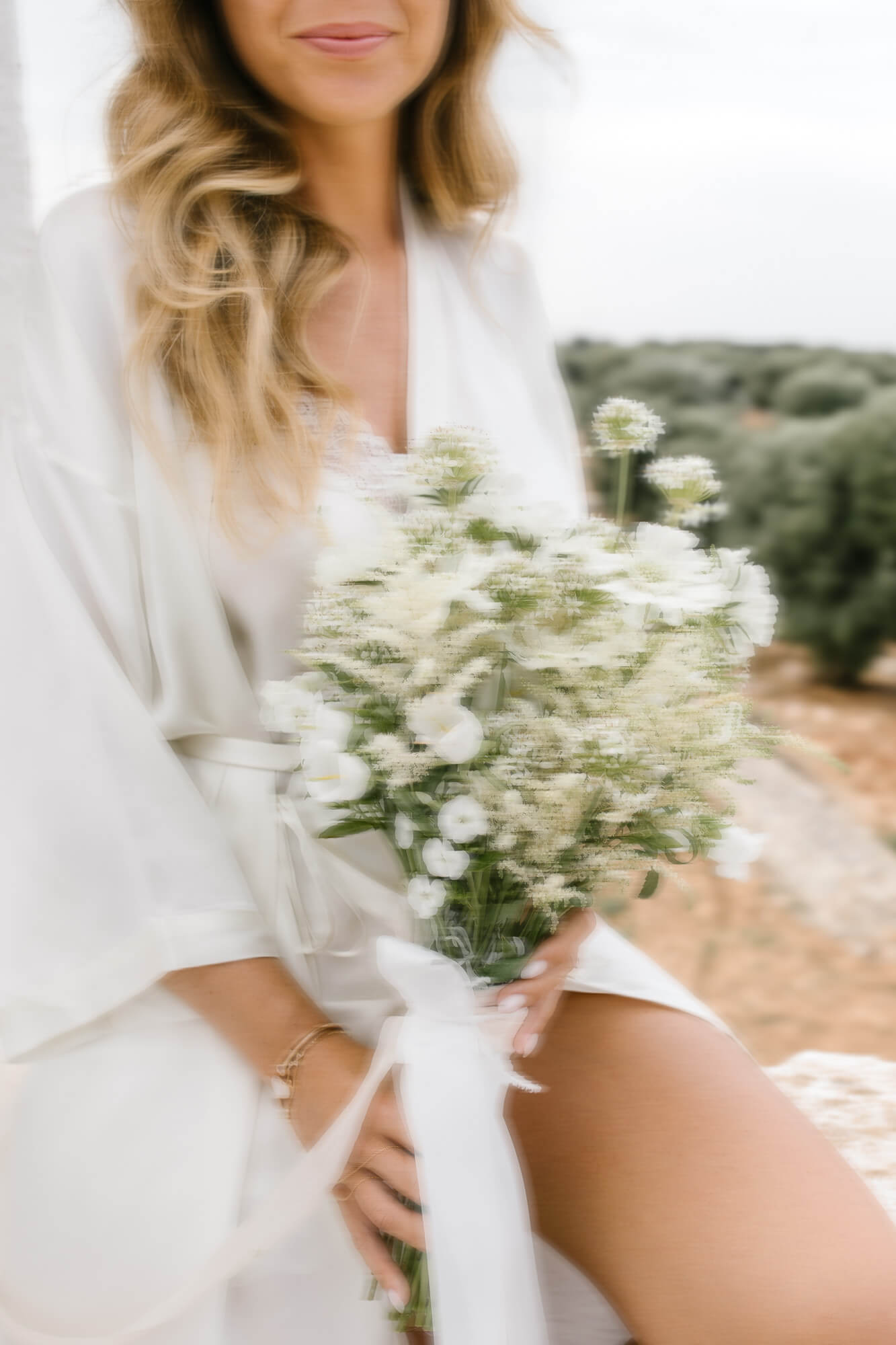 Bride holding her white wildflower bouquet