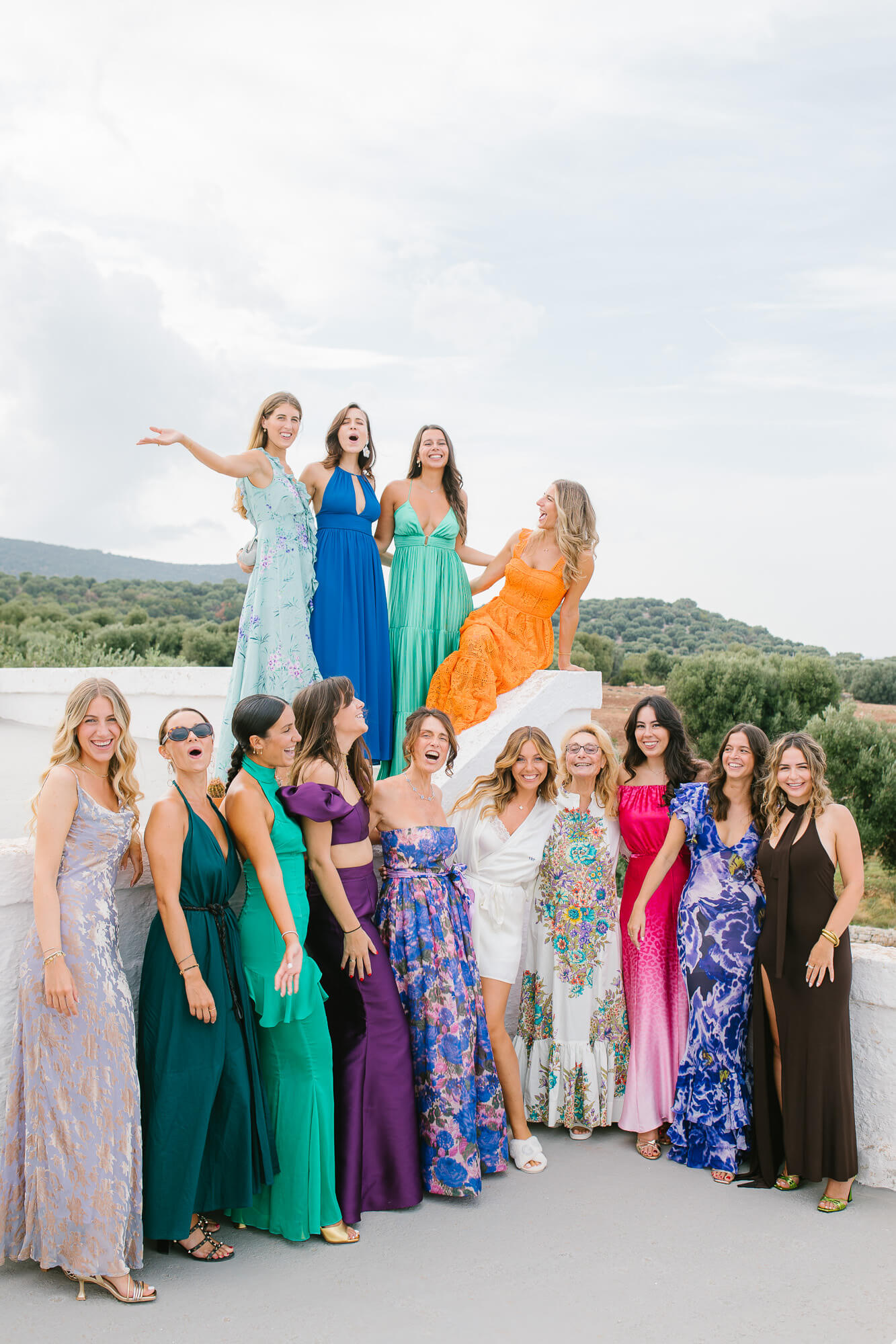 Bride and bridesmaids in colourful dresses on the masseria terrace