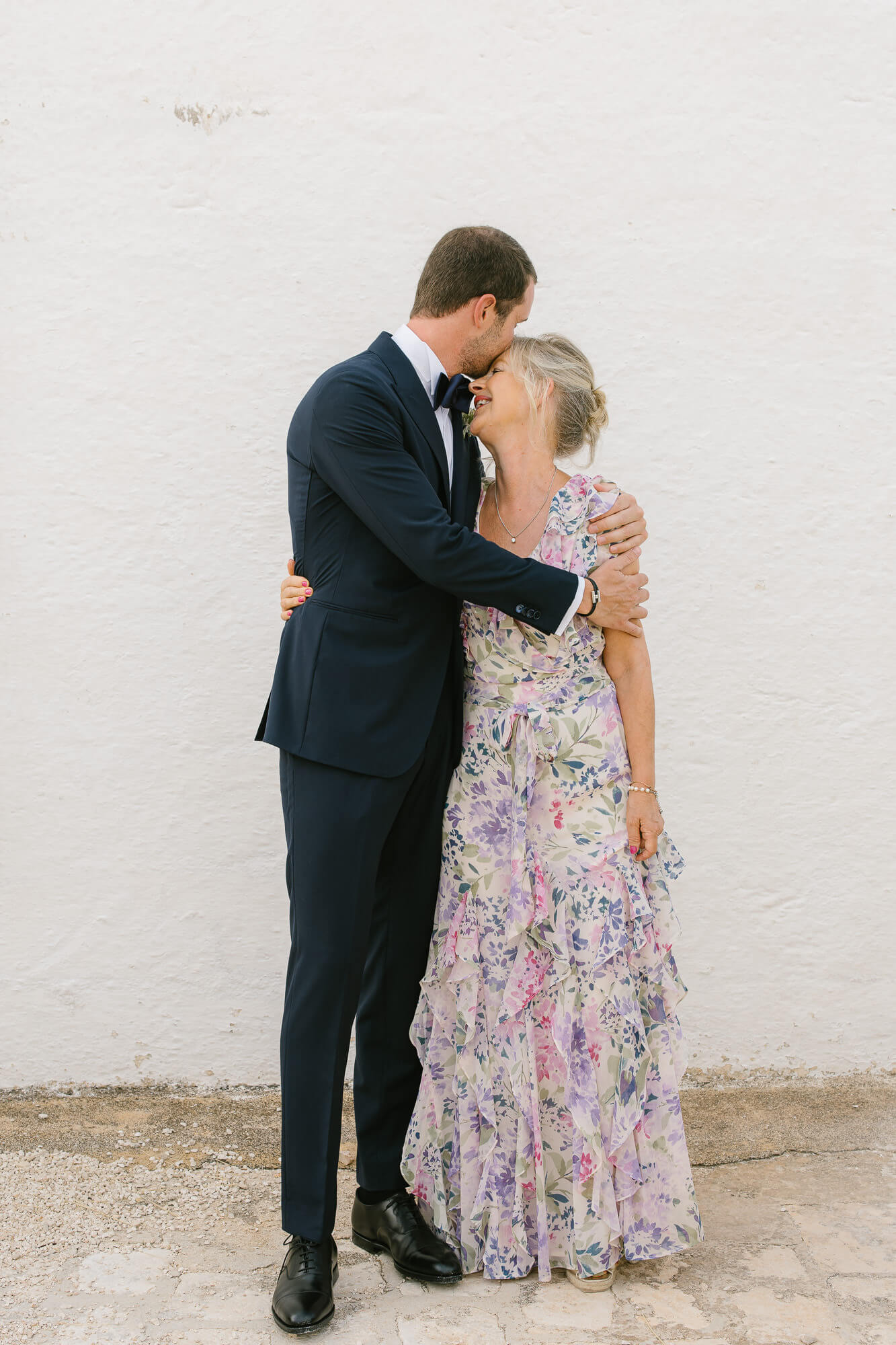 Groom hugging his mother before the ceremony