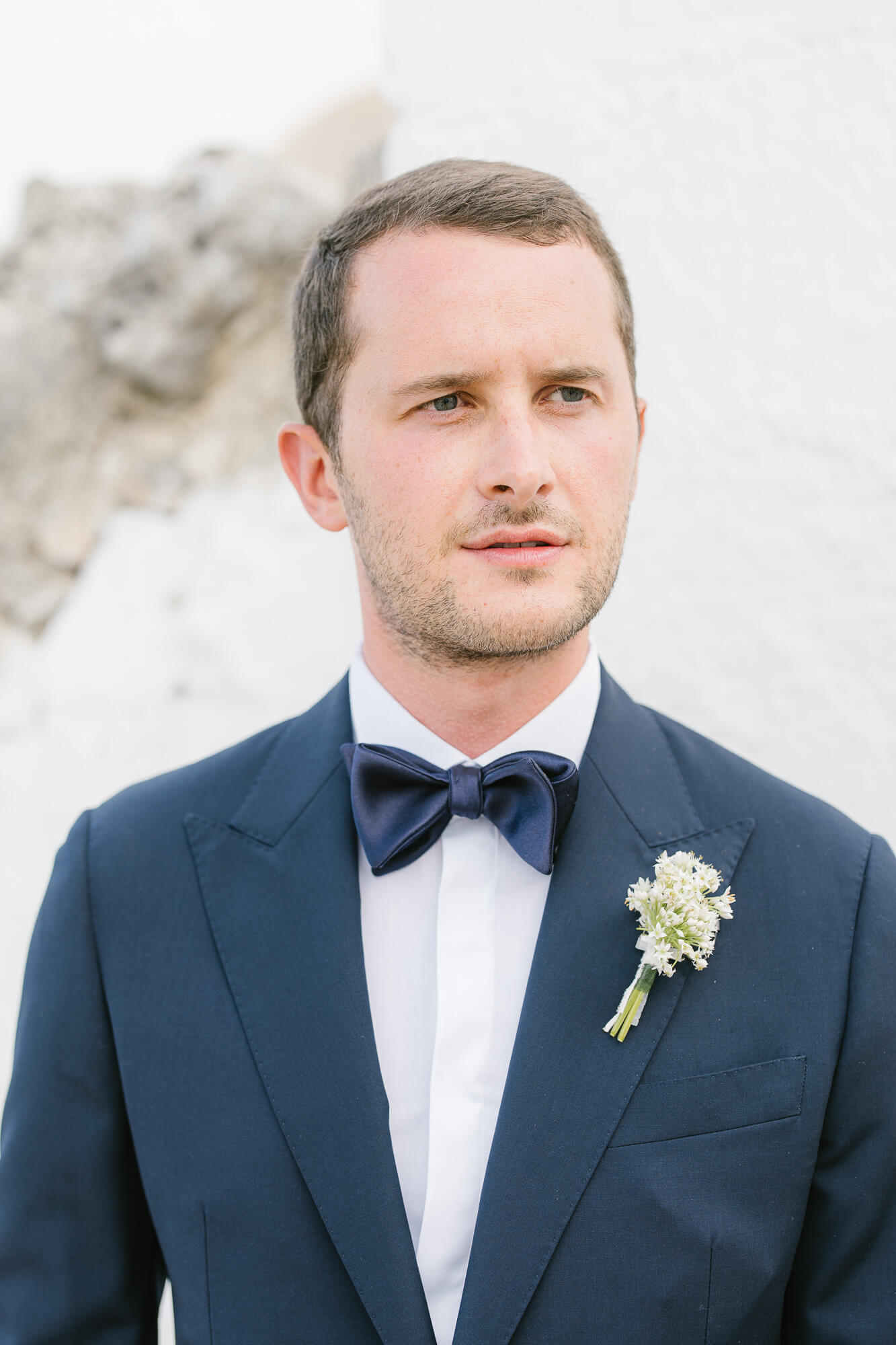 Portrait of the groom in a navy tuxedo