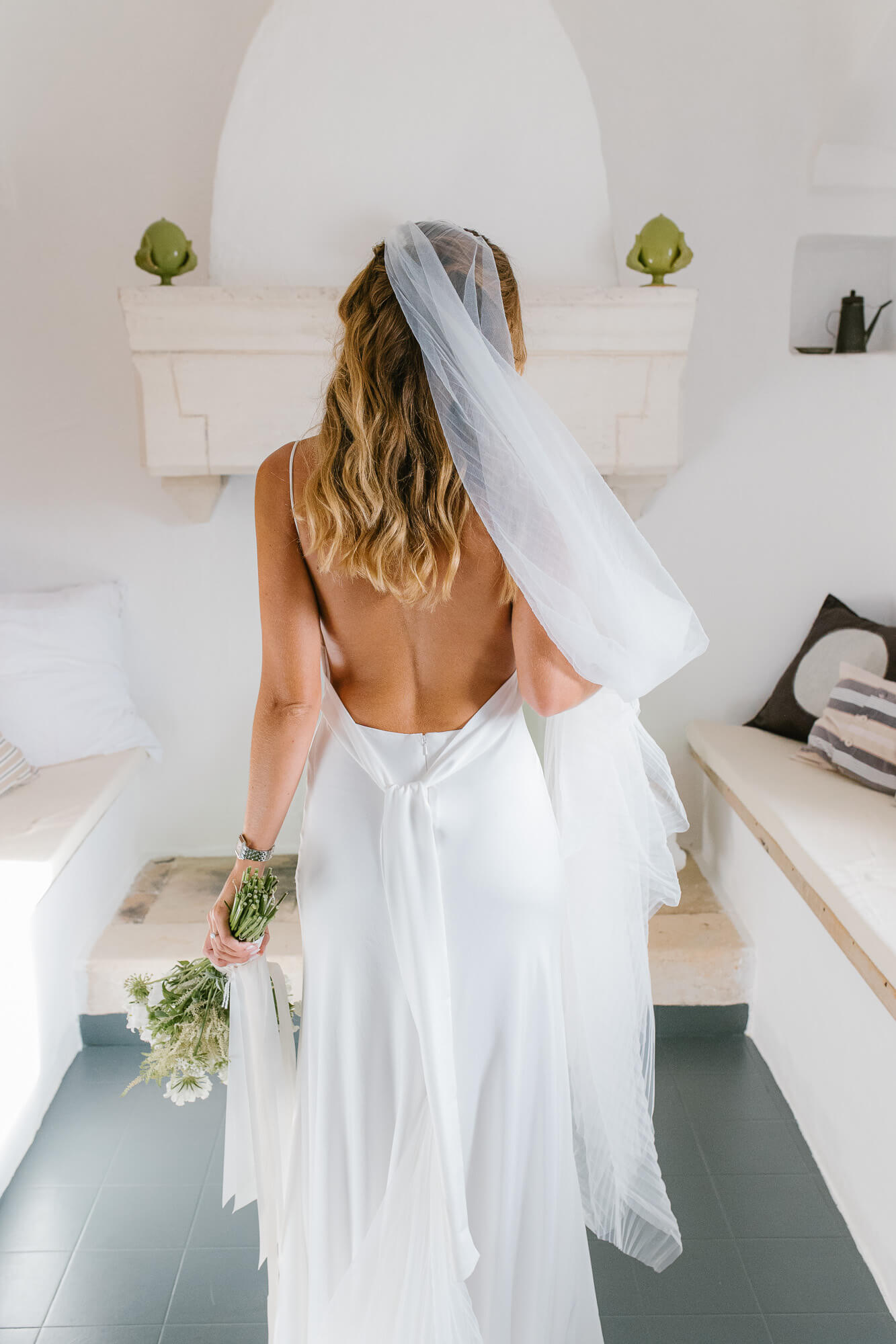 Open-back wedding dress inside the masseria