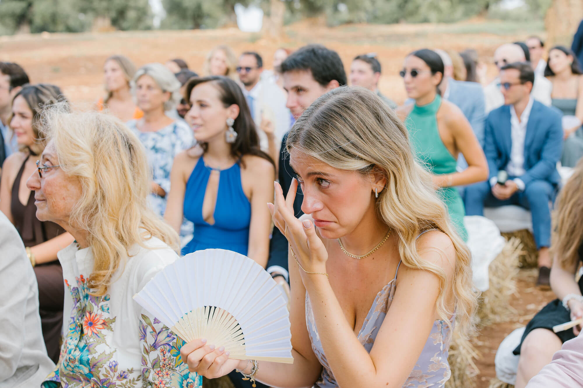 Guest wiping away a tear during the olive grove ceremony