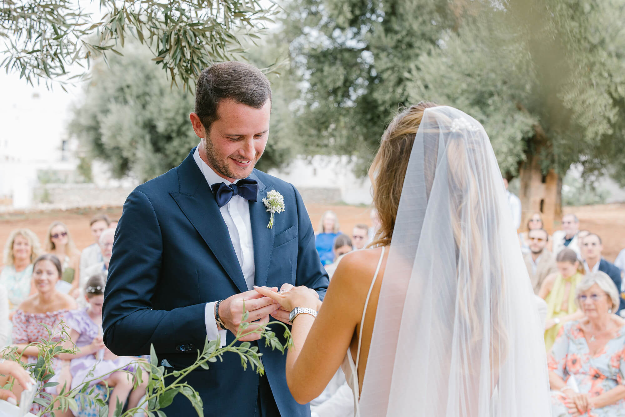 Groom placing the ring on the bride's finger