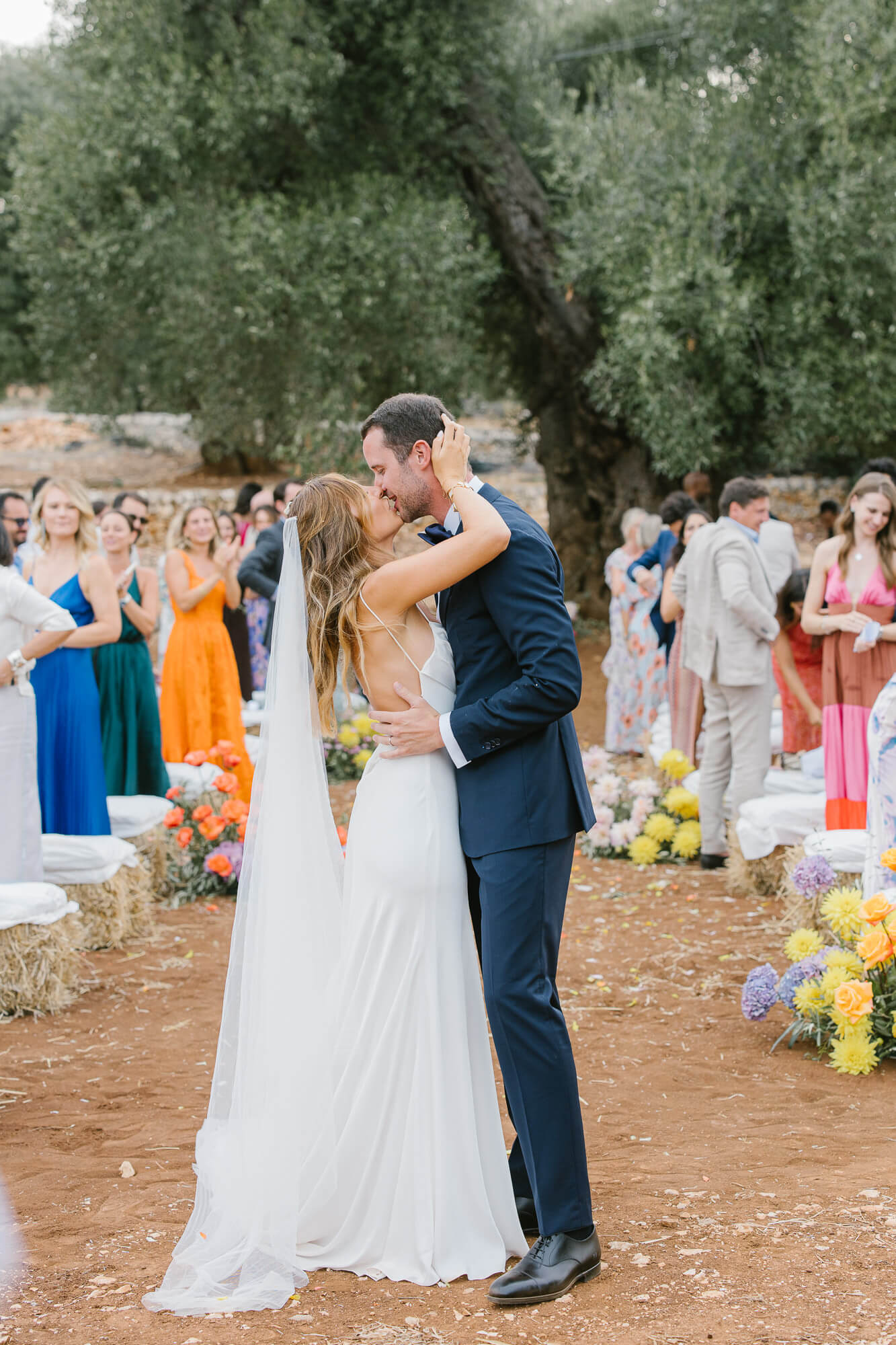First kiss as newlyweds under the olive tree