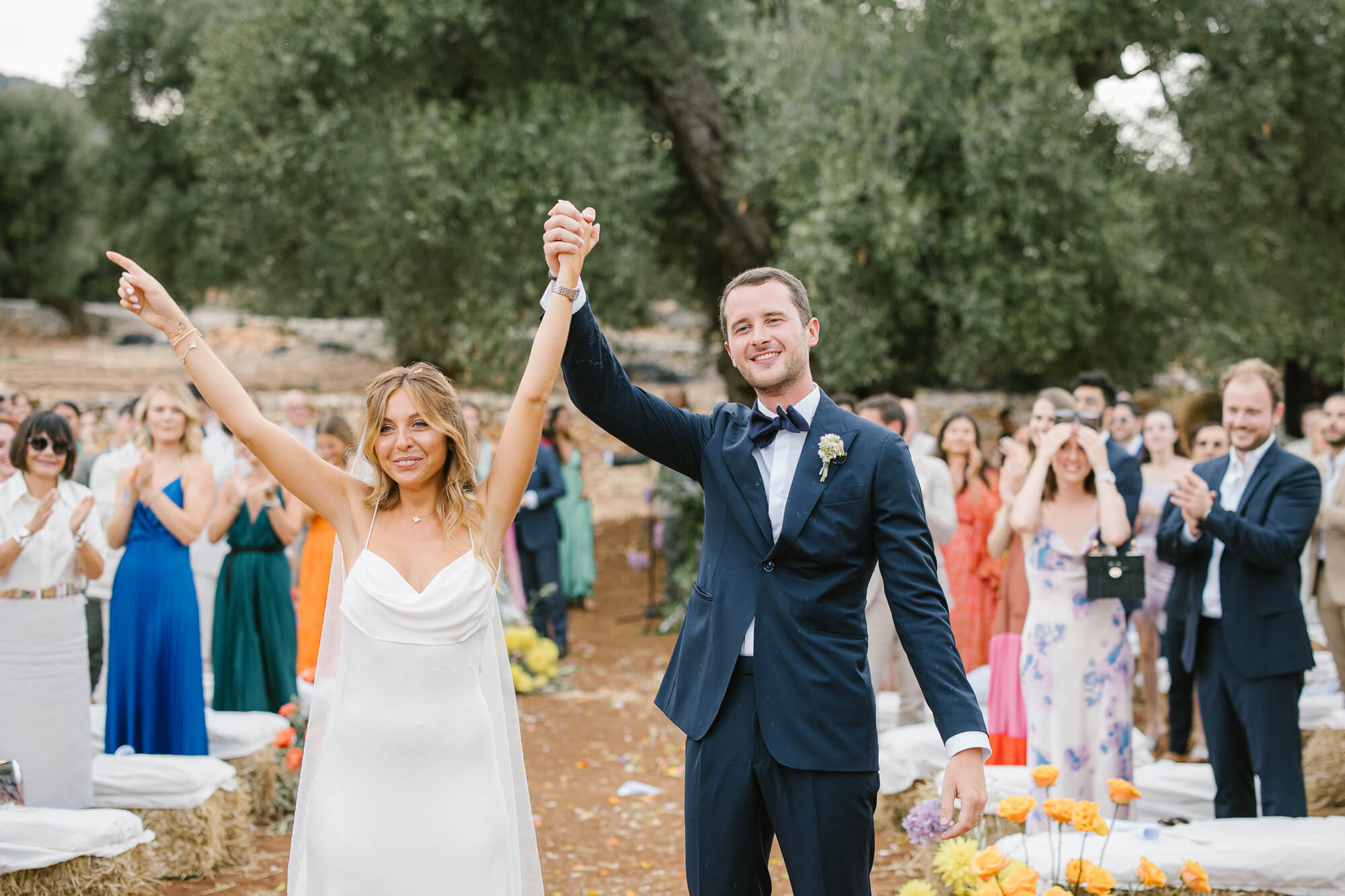 Newlyweds celebrating with arms raised