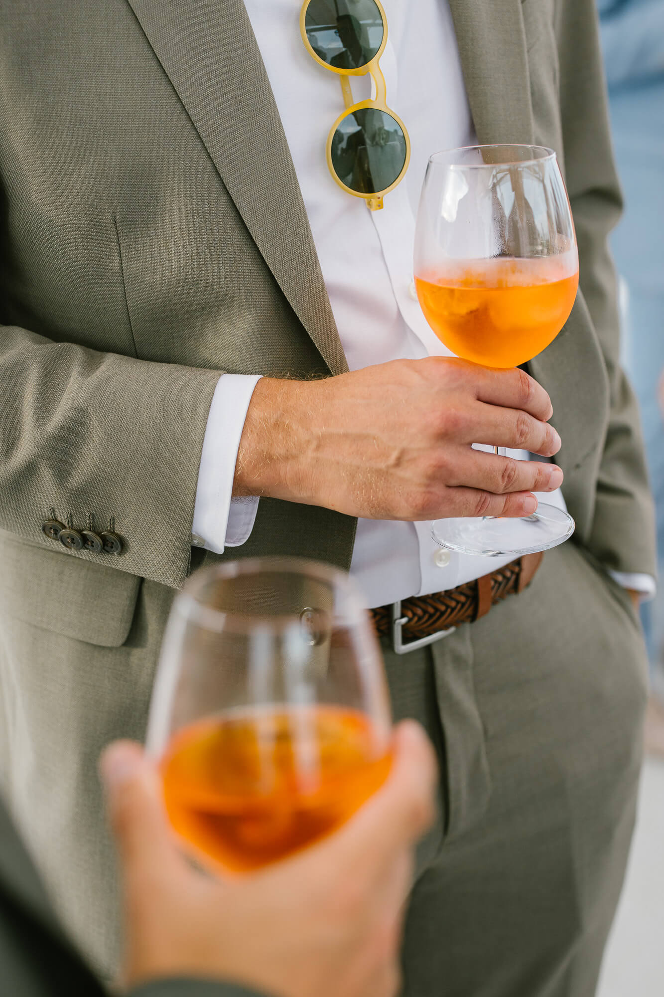 Guests holding orange spritz at the aperitivo
