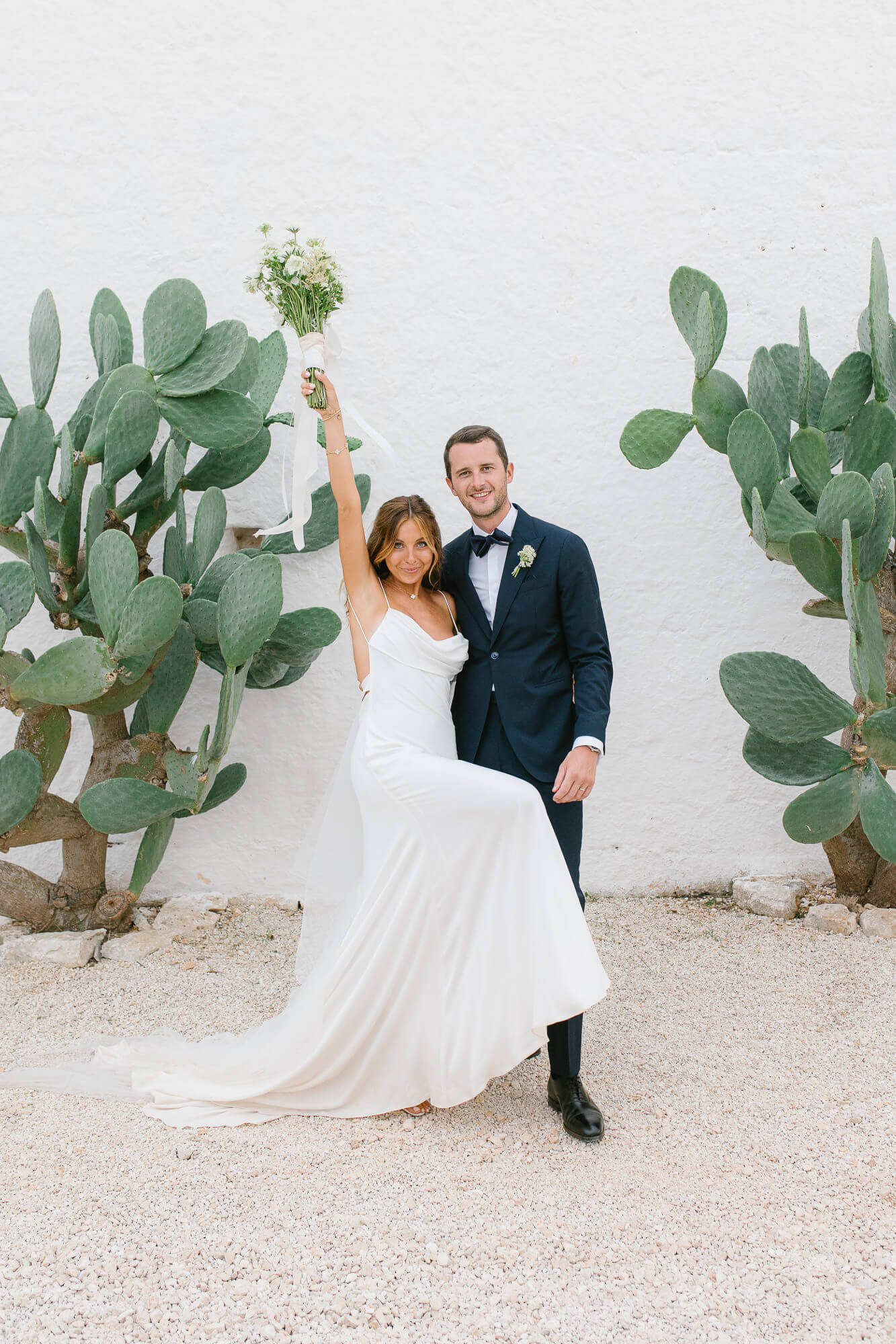 Bride and groom twirling by the prickly pears