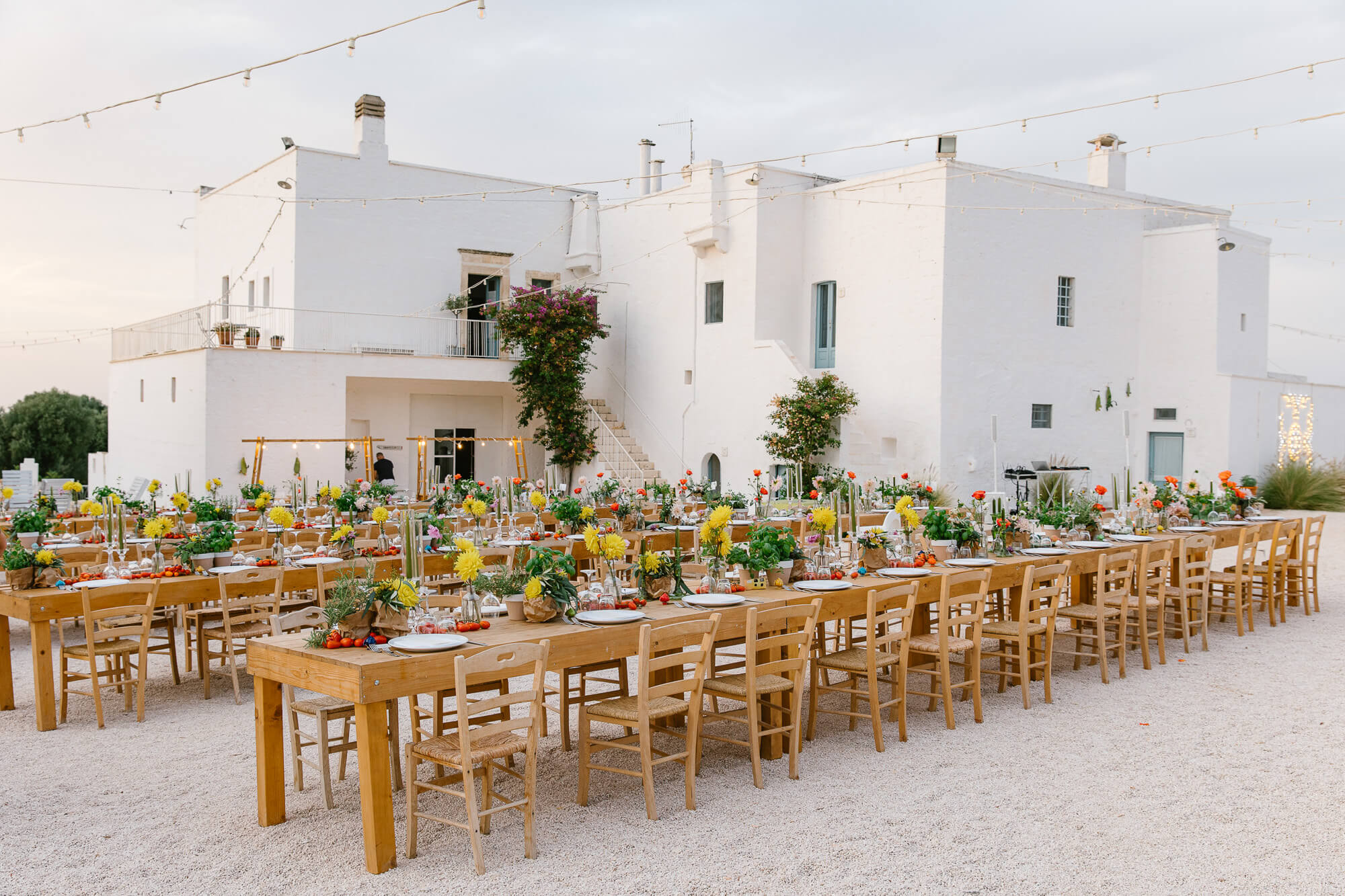 Long wedding tables in the courtyard of Masseria Mozzone