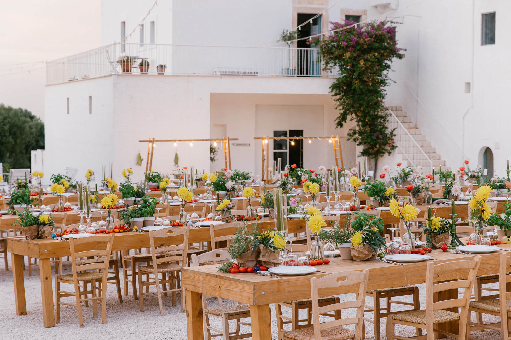 Long wedding tables in the courtyard of Masseria Mozzone