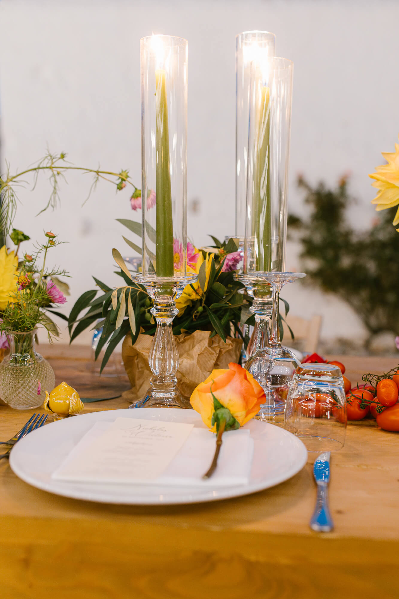Candles, flowers and menu on a wedding table at Masseria Mozzone