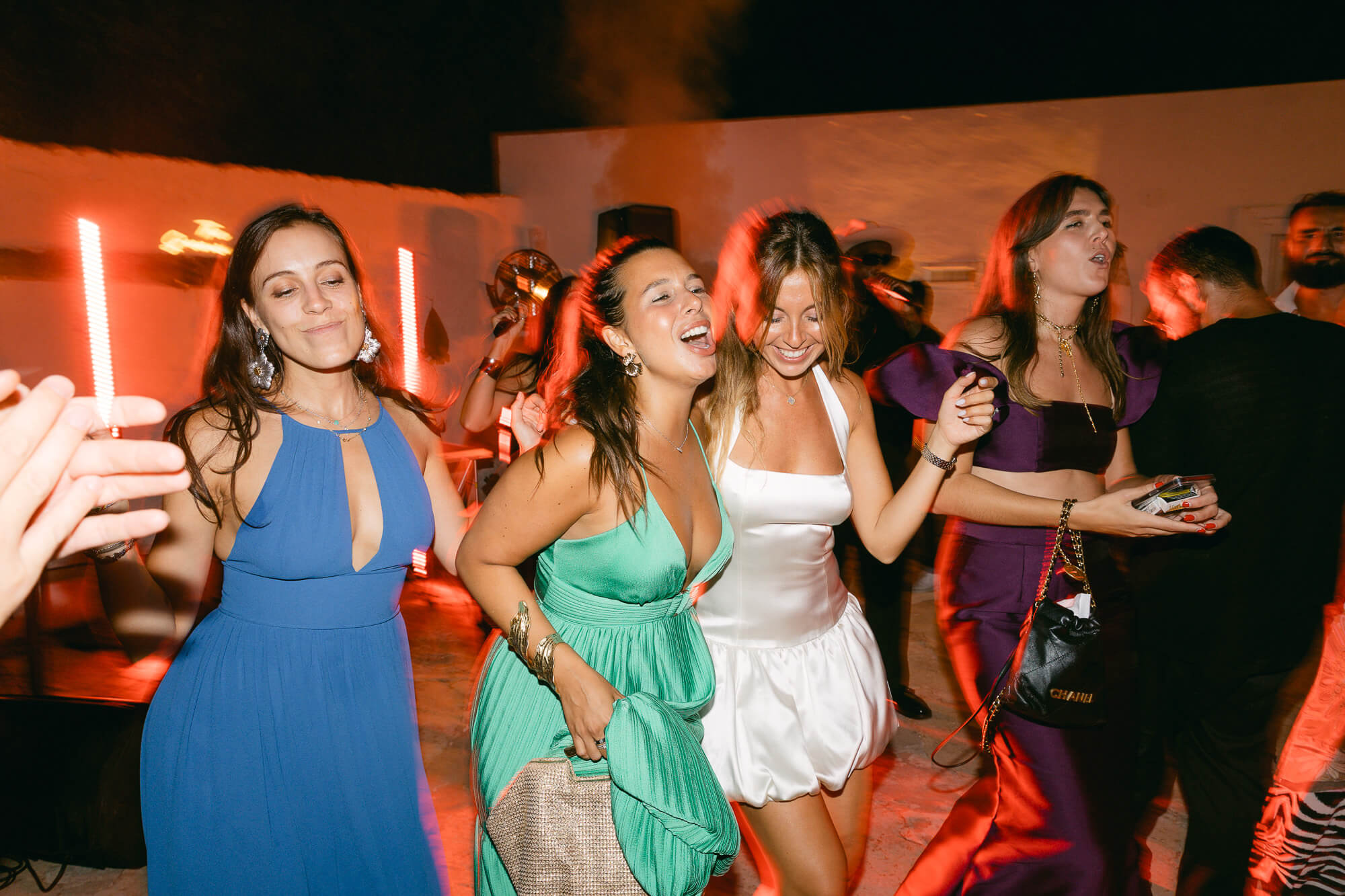 Bride dancing with her friends late at night