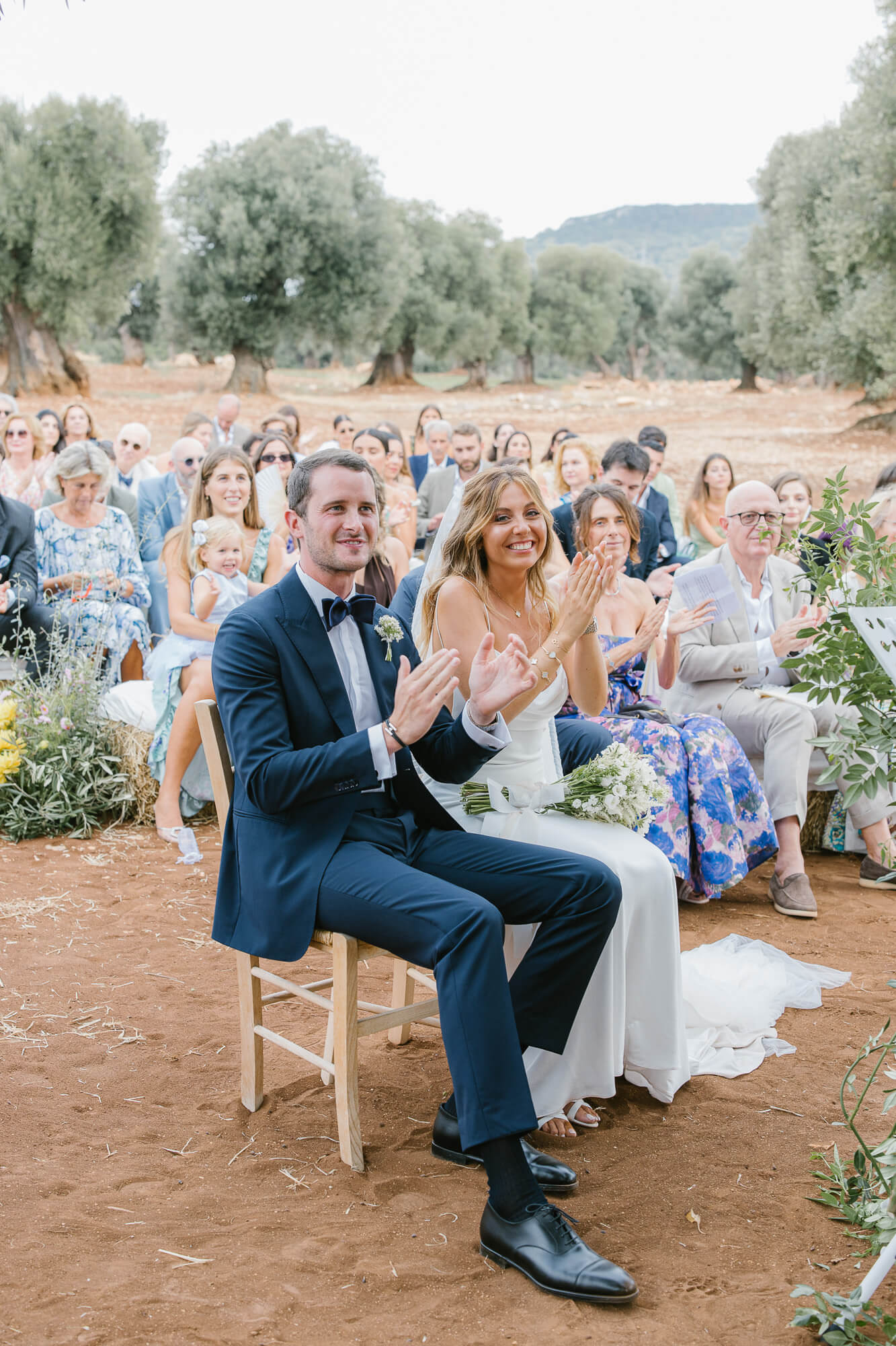 Bride and groom applauding during the wedding readings