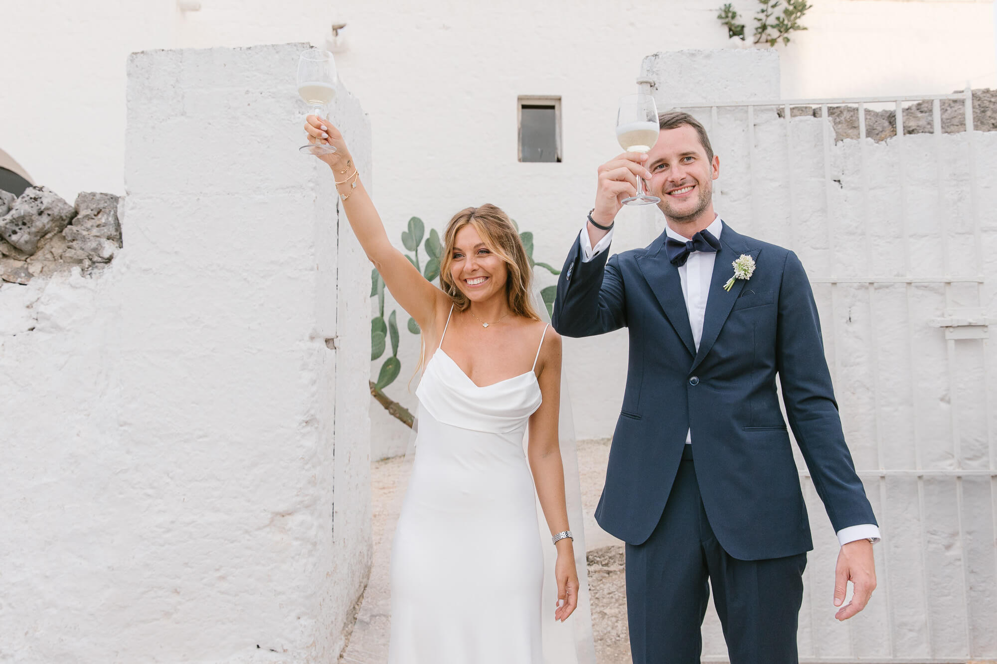 Newlyweds raising a toast to their guests at Masseria Mozzone